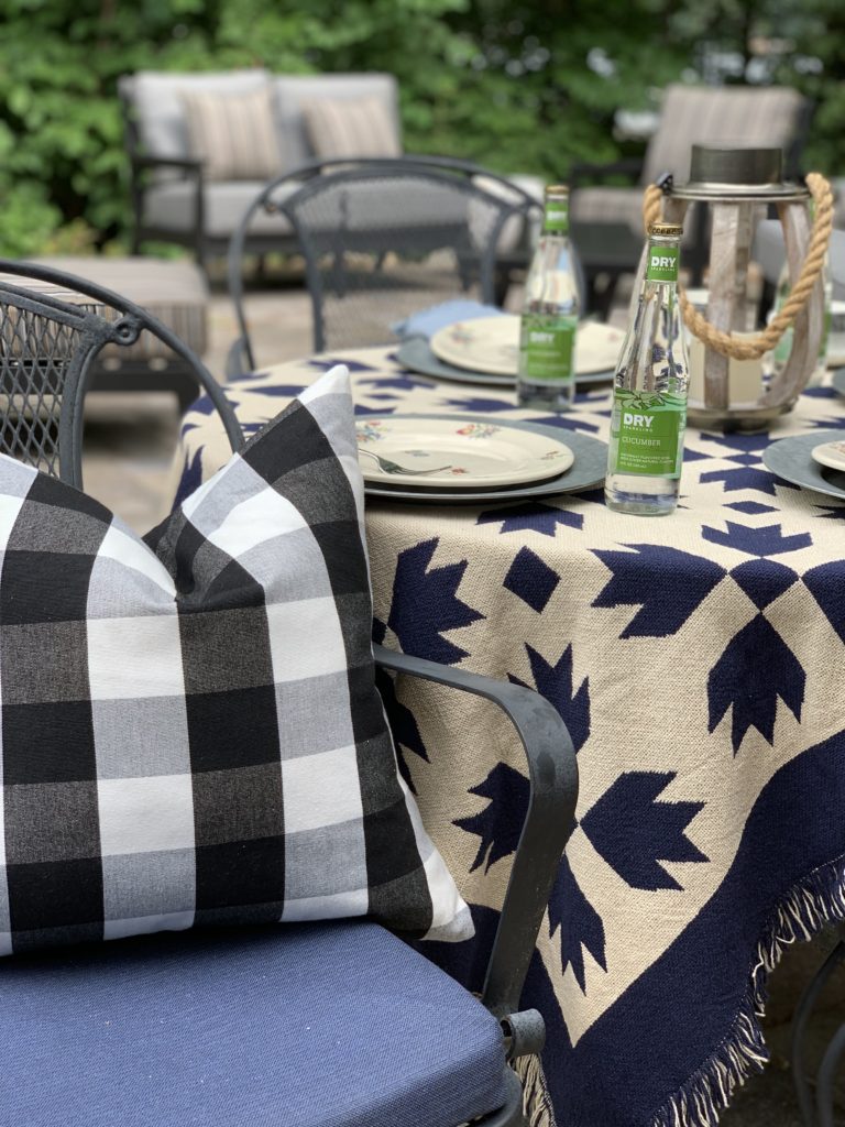 Summer outdoor tablescape with buffalo plaid pillow